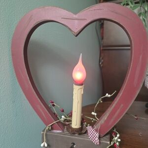 Primitive or rustic wooden heart candle holder with a faux candle